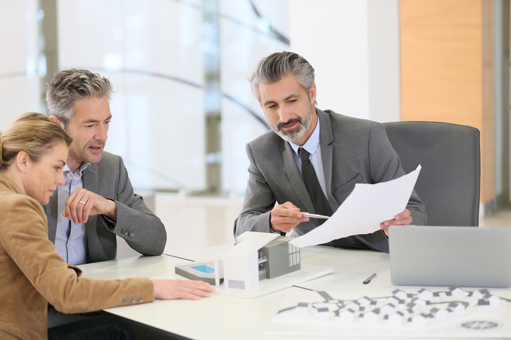 Mature couple meeting architect for construction project